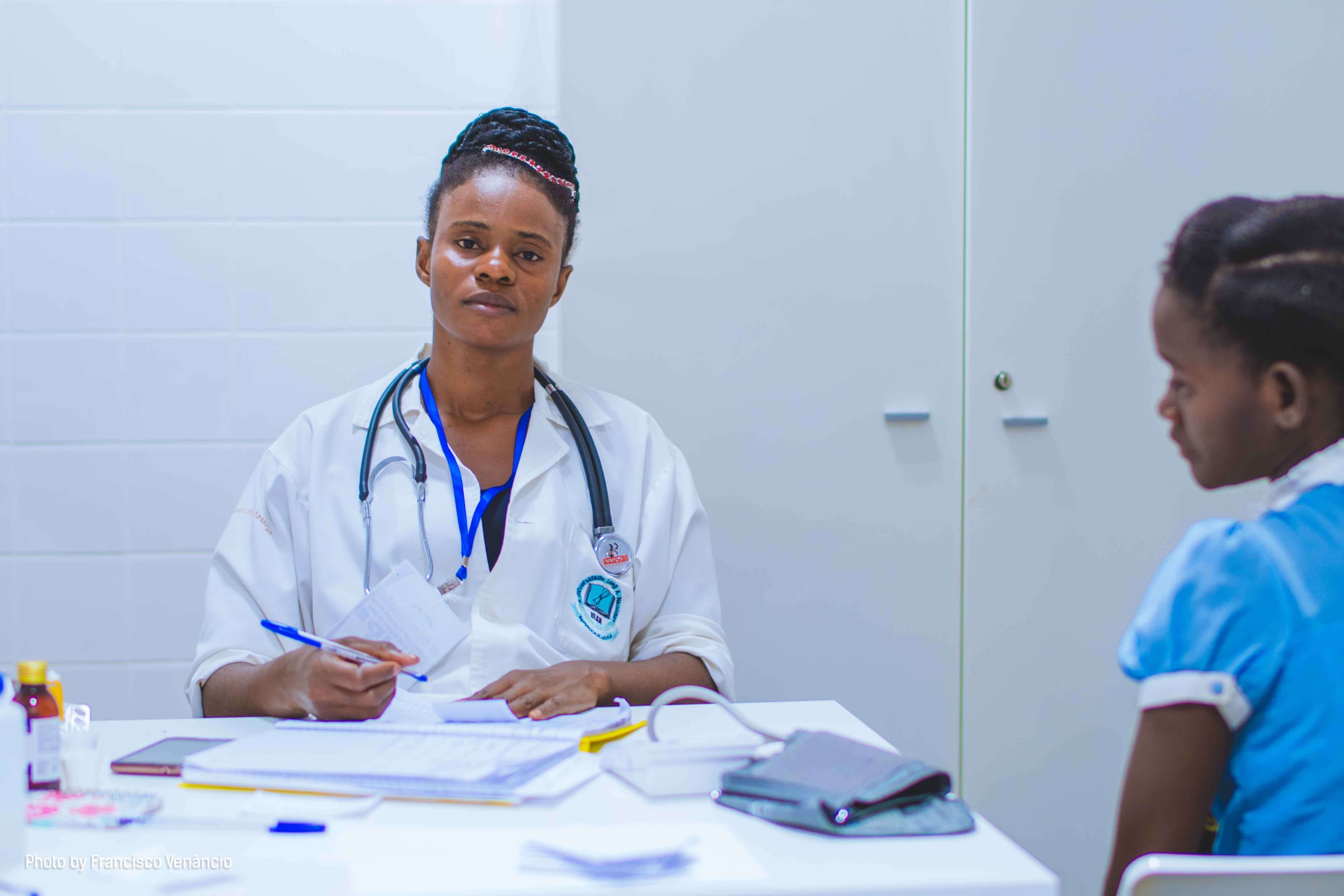 A doctor attending to a young girl